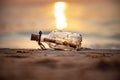 Message in the bottle against the Sun setting down Royalty Free Stock Photo