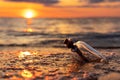 Message in the bottle against the Sun setting down Royalty Free Stock Photo