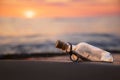 Message in the bottle against the Sun setting down