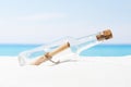 Message in bottle on beach with white sand,in tropical sea Royalty Free Stock Photo