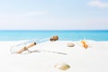 Message in bottle on beach with white sand,in tropical sea Royalty Free Stock Photo