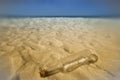 Message in a bottle in the sand of the beach Royalty Free Stock Photo