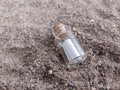 Message in a bottle on the sand at the beach Royalty Free Stock Photo