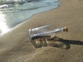 Message in a bottle on the sand beach help concept Royalty Free Stock Photo