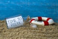 Message in a bottle with time to relax and maritime decoration in front of a weathered blue wood Royalty Free Stock Photo