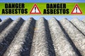 The message `danger asbestos` written on a yellow stripe