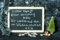 On a Christmas background a blackboard with a message from child to father: Drive carefully, we are waiting for you Royalty Free Stock Photo