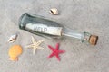 Message in a glass bottle on sand Royalty Free Stock Photo