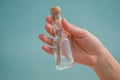 Message in a glass bottle in a woman`s hand. Sea and blue sky. Found a note on salvation, please help Royalty Free Stock Photo