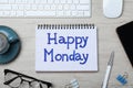 Message Happy Monday written in notebook, computer keyboard and cup of coffee on wooden  desk, flat lay Royalty Free Stock Photo