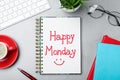 Message Happy Monday written in notebook, office stationery and cup of coffee on light desk, flat lay Royalty Free Stock Photo