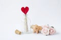 Message in open bottle with red heart paper with happy smiling elephant clay