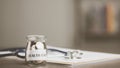 message on paper and coins in glass jar, stethoscope and medical report, all on table, savings concept, for health care expenses, Royalty Free Stock Photo