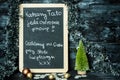 On a Christmas background a blackboard with a message from child to father: Drive carefully, we are waiting for you Royalty Free Stock Photo