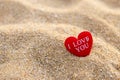 Message on red heart on sand beach, love and romance concept Royalty Free Stock Photo