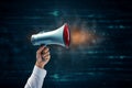 Message space Megaphone and hand displayed on blue chalkboard backdrop