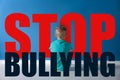 Message STOP BULLYING and sad little boy sitting Royalty Free Stock Photo