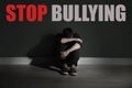 Message STOP BULLYING and sad young man
