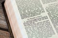 The message to Smyrna Church from God Jesus Christ, an open Holy Bible Book Revelation on wooden background