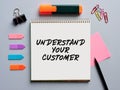 The message understand your customer written on a notebook on office desktop. Customer care in business Royalty Free Stock Photo