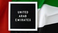 Message UNITED ARAB EMIRATES on background waving flag of UAE. National holiday, Independence Commemoration Day Muslim Royalty Free Stock Photo