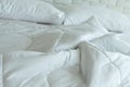 Messed bed with white pillow and blanket with natural light in bedroom in the morning Royalty Free Stock Photo