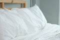 Messed bed with white pillow and blanket with natural light in bedroom in the morning Royalty Free Stock Photo