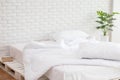 Messed bed with white pillow and blanket with natural light Royalty Free Stock Photo