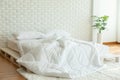 Messed bed with white pillow and blanket with natural light Royalty Free Stock Photo