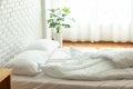 Messed bed with white pillow and blanket with natural light Royalty Free Stock Photo