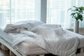 Messed bed with white pillow and duvet blanket with natural light in bedroom in the morning,Messy bed after wake up,Messy bed and Royalty Free Stock Photo