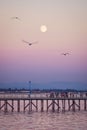 Moonrise on a popular pier at dusk Royalty Free Stock Photo