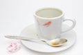 Messthetics aesthetic concept. A photo of the red lipstick marks on your coffee cup. Dirty empty white ceramic cup on the plate, s Royalty Free Stock Photo