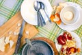 Messthetics concept. An overhead photo of dirty bowls with oatmeal porridge leftovers, half of pomegranate, tea spoons and knife, Royalty Free Stock Photo