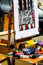 Messy artist`s easel with canvas painted