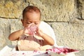 Messy baby boy poring water from glass Royalty Free Stock Photo