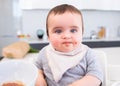 Messy baby eating food in kitchen Royalty Free Stock Photo