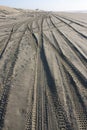 Messy beach sand with tyre tracks Royalty Free Stock Photo