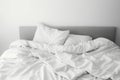 Messy Bed Concept With White Bedding Sheets And Pillow