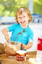 Messy, boy or bowl in mixing, baking or playful meal prep as learning, activity or child development. Young male person Royalty Free Stock Photo