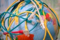 A messy cable plexus is on the world map. Many of tangled internet wires entangle around the globe. The Internet network covers Royalty Free Stock Photo