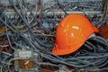 Messy cables electricity and communication lines with engineer worker hardhat safety helmet