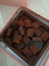 Messy chocolate cube. Truffle chocolate in a box