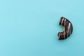 Messy chocolate doughnut isolated on blue background Royalty Free Stock Photo