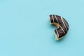 Messy chocolate doughnut isolated on blue background Royalty Free Stock Photo