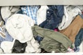 Messy closet filled with different used unfresh clothes, sloppily shoved,hanging from shelves. Fast fashion. Pile of Royalty Free Stock Photo