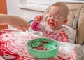 Messy and dirty baby is eating and crying Royalty Free Stock Photo