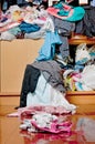 Messy disorder clothes over the closet. Untidy cluttered woman c