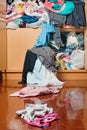 Messy disorder clothes over the closet. Untidy cluttered woman c