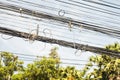 Messy electrical cables in thailand - Uncovered optical fiber technology open air outdoors asian cities Royalty Free Stock Photo